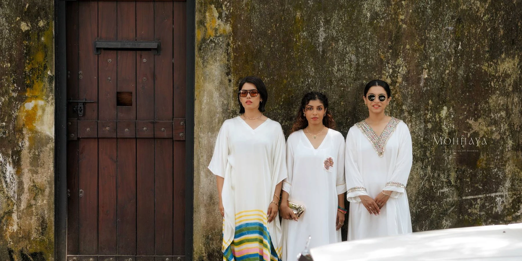 Ivory kaftans and kurtas photographed in an old Kochi lane